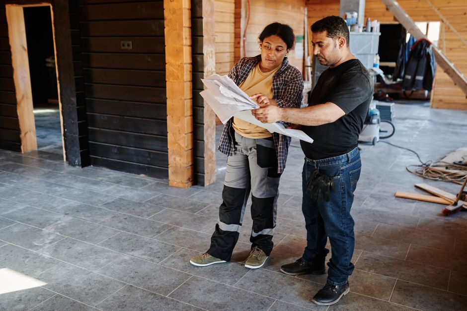 General contractor reviewing home remodeling blueprints